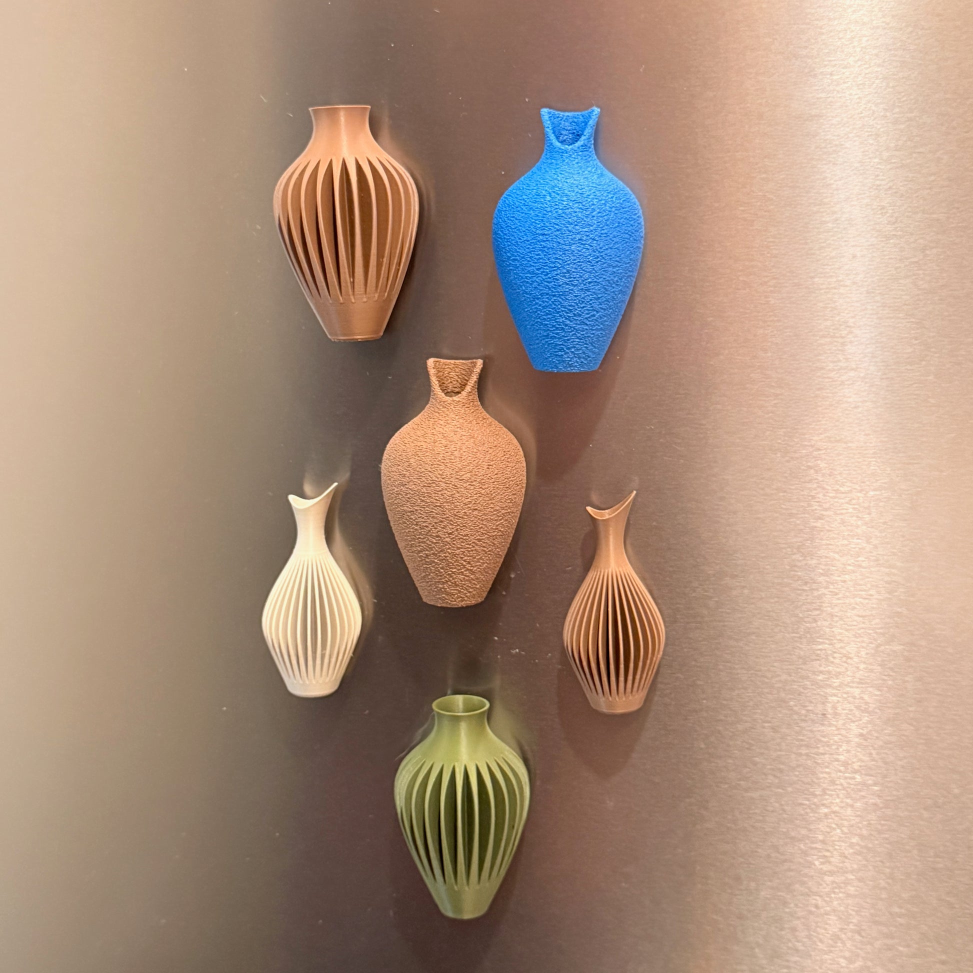 Mini Magnetic Vase Trio ‚Äì Set of 3 Modern Fridge Vases on a kitchen surface, featuring multiple colors and designs, ideal Refrigerator Magnet Vases for a contemporary touch.