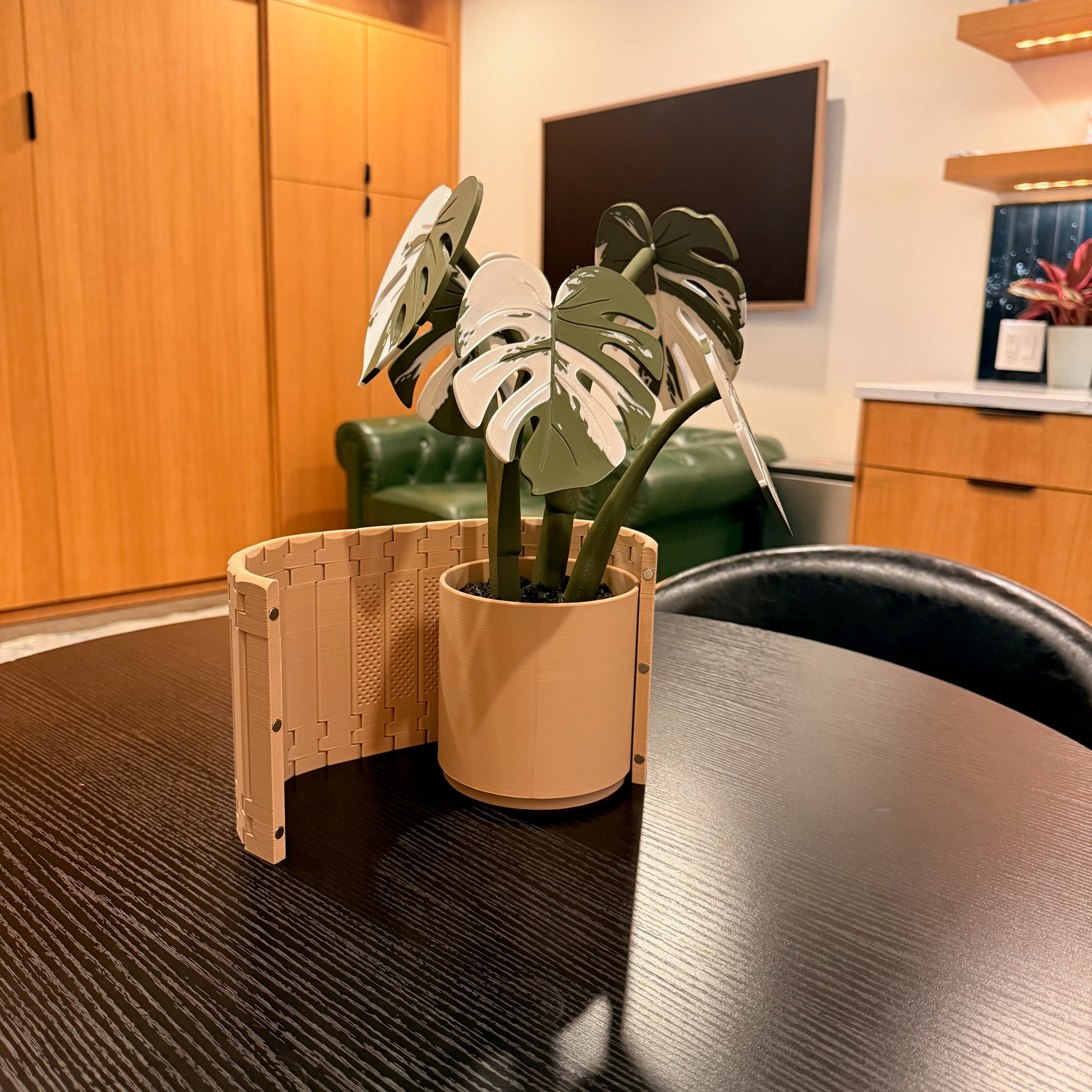 Variegated Monstera Coaster Set beautifully arranged in a living room setting with an elegant caddy and armchair valet.