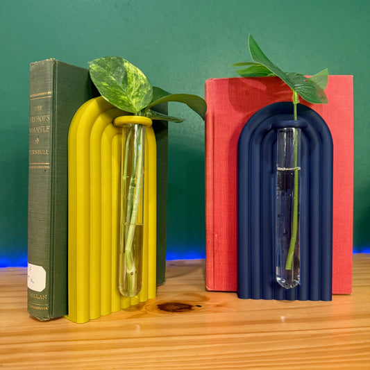 Colorful propagation bookends with built-in glass tubes showcasing plant cuttings, enhancing home decor and organization.
