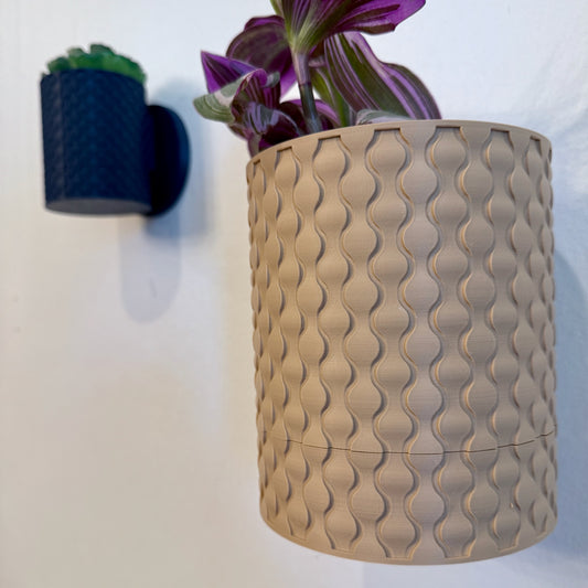 A sleek and modern raindrop-shaped wall planter, perfect for displaying herbs, succulents, or trailing vines while saving space.