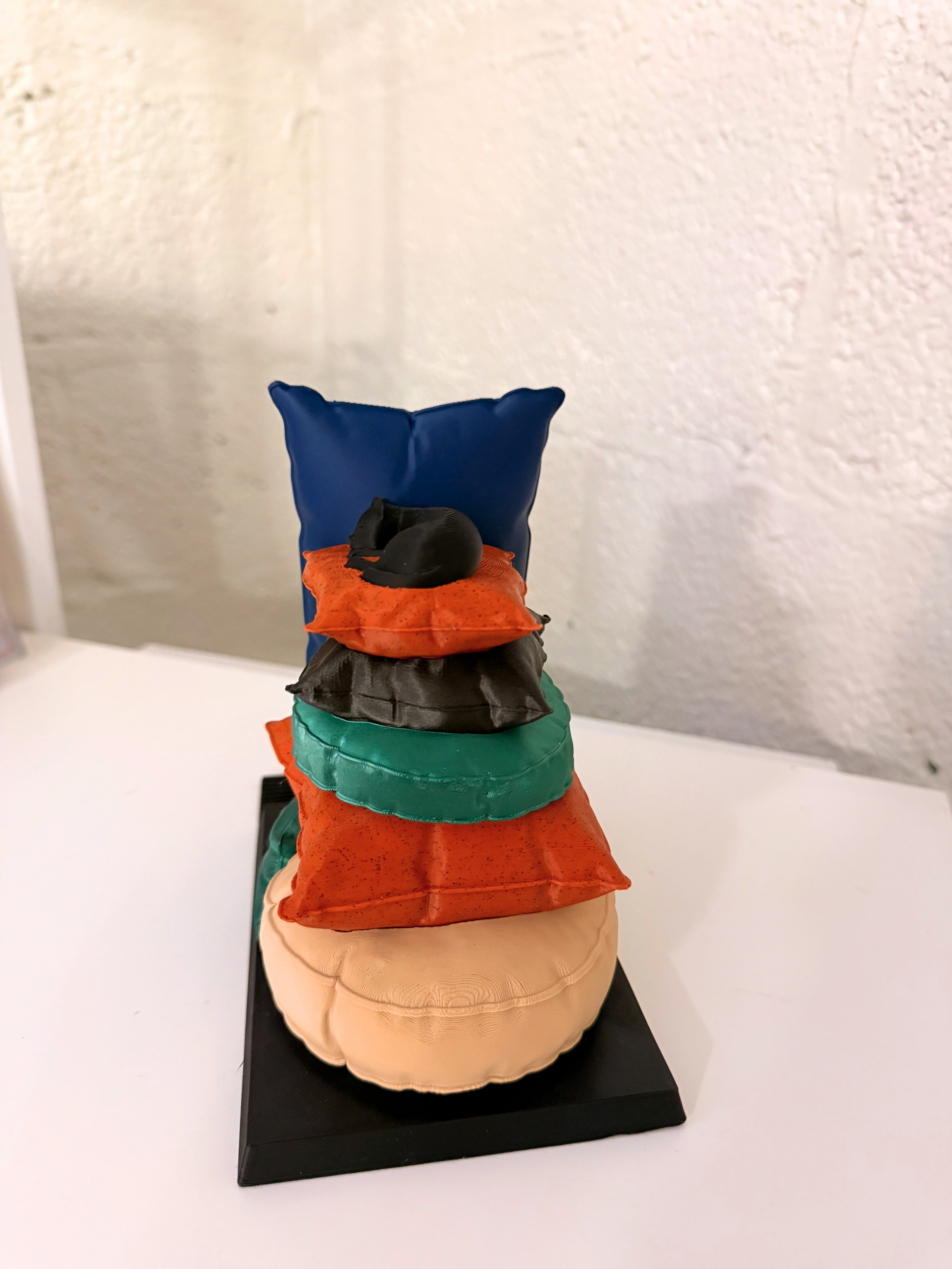 Back view of the Sleepy Cat Bookend with its whimsical design of stacked pillows, illustrating its functionality and appeal for cat enthusiasts.